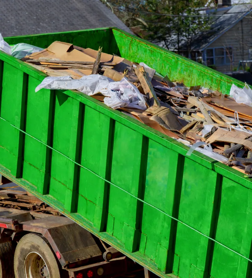 Green roll-off dumpster from Dump Pro Dallas used for residential construction debris removal