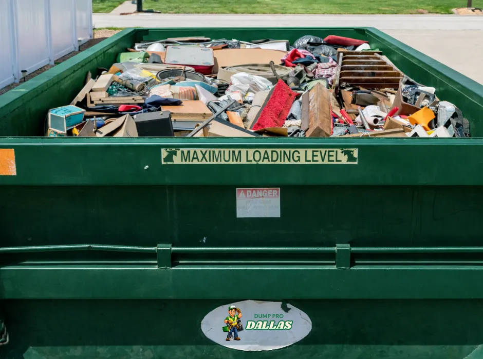 Loaded green roll-off dumpster on a jobsite in Dallas, Texas