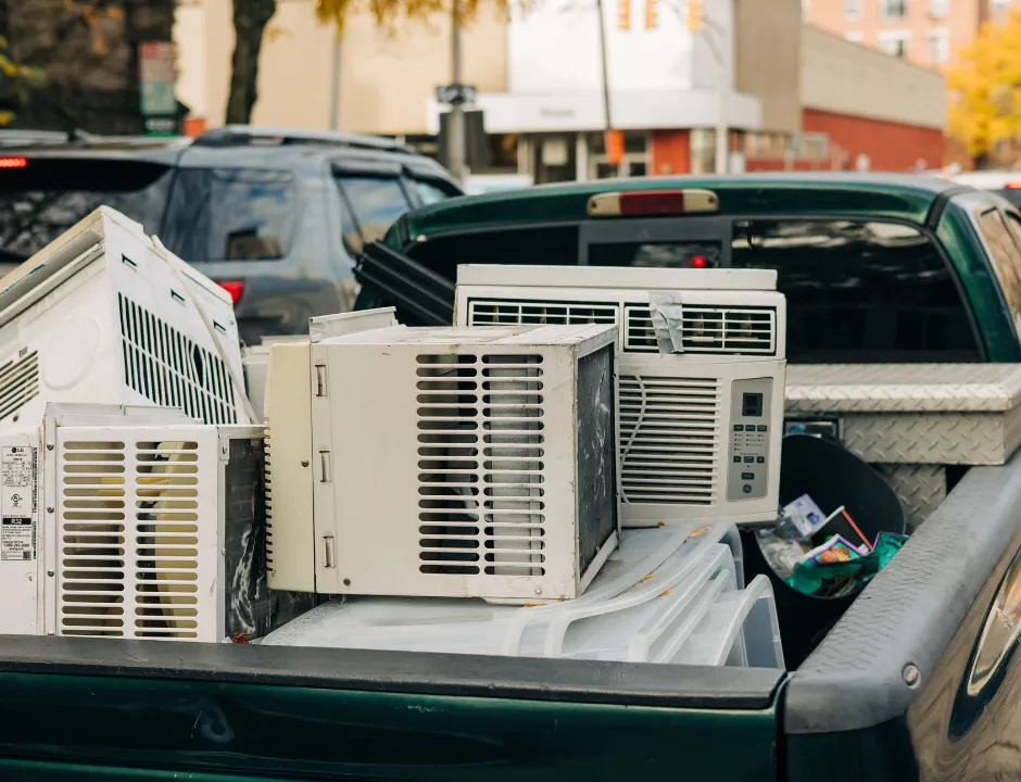 Pickup truck loaded with junk and appliances for professional hauling service