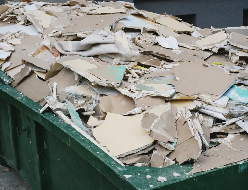 Renovation waste hauling with drywall scraps and construction debris ready for removal