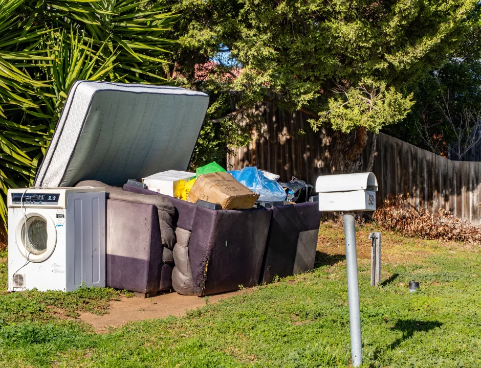 Residential junk removal with old furniture and appliances prepared for pickup